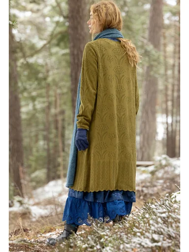 A woman wearing a green knit dress from Gudrun Sjödén.