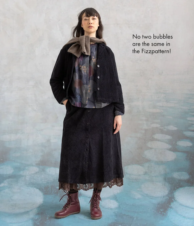 A woman wearing a jacket and skirt in corduroy from Gudrun Sjödén.