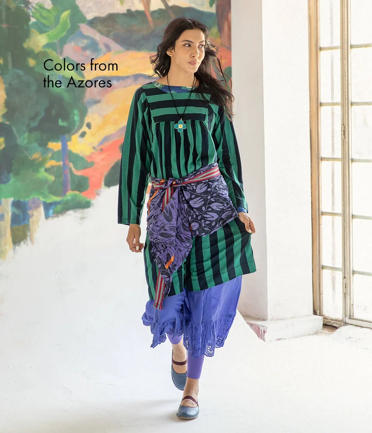 A woman wearing a striped dress from Gudrun Sjödén.