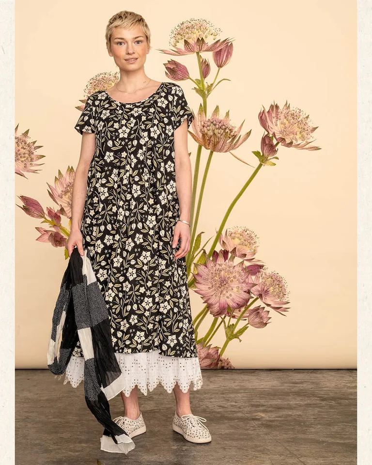 A woman wearing a patterned dress from Gudrun Sjödén.