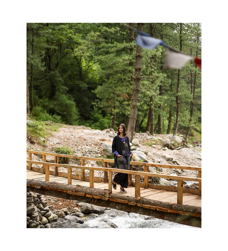 A woman wearing layers of clothing from Gudrun Sjödén.