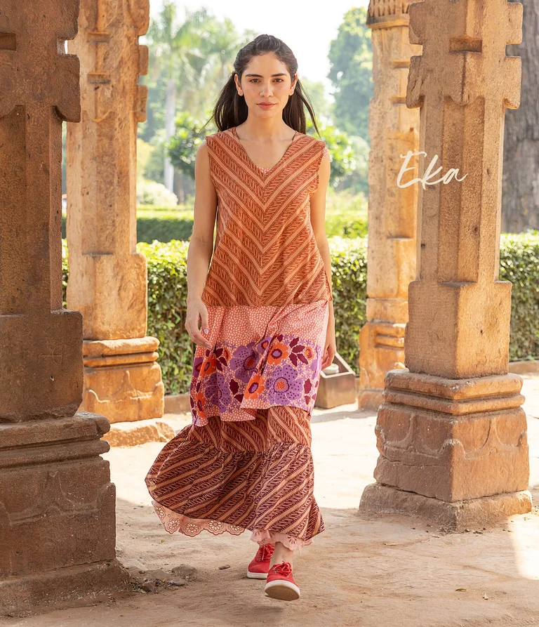 A woman wearing layers of patterned clothing from Gudrun Sjödén.