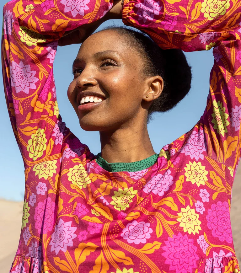 A woman wearing a floral dress from Gudrun Sjödén.
