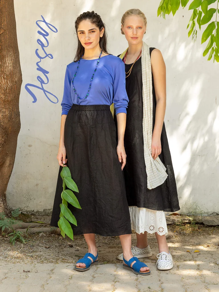 Two women wearing solid-colored clothing from Gudrun Sjödén.