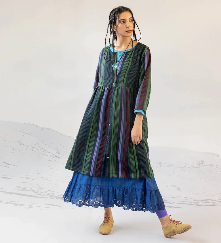 A woman wearing layers of clothes from Gudrun Sjödén’s 2025 Christmas collection.