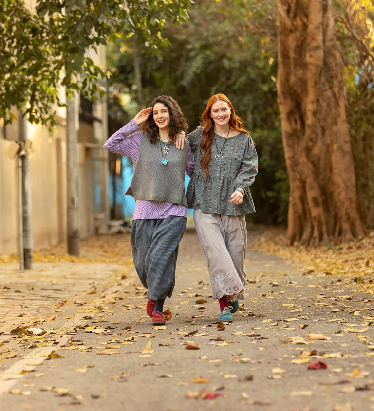 Two women wearing clothing in shades of gray-purple from Gudrun Sjödén.