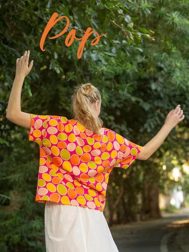 A woman wearing a pink dotted top from Gudrun Sjödén.