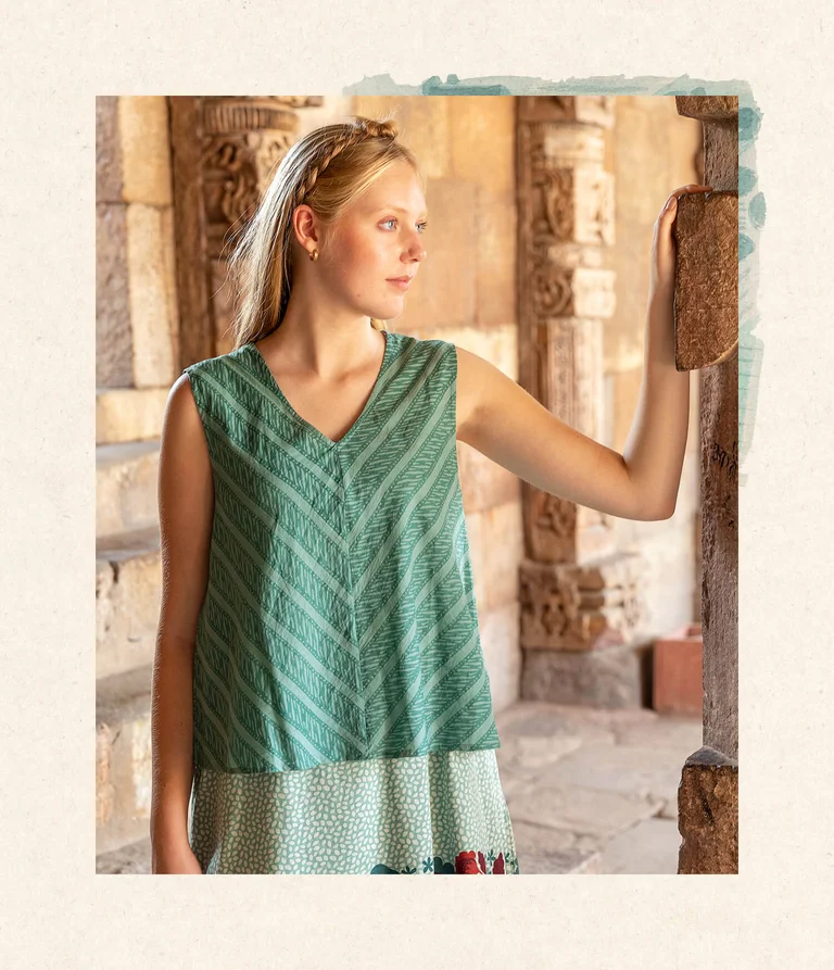 A woman wearing a striped green blouse from Gudrun Sjödén.