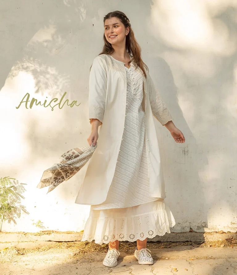 A woman wearing layers of white clothing from Gudrun Sjödén.