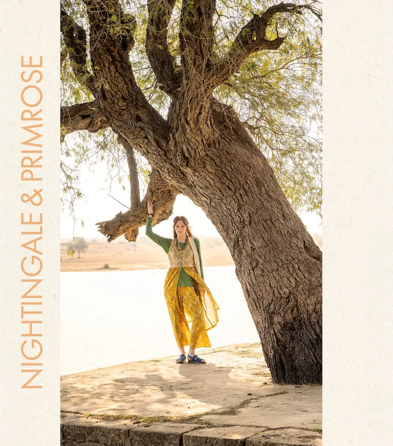 A woman wearing a floral dress and floral trousers from Gudrun Sjödén.