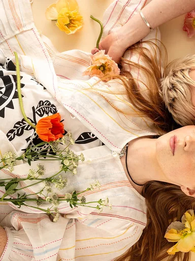 Two women wearing clothes from Gudrun Sjödén’s 2025 High Summer collection.