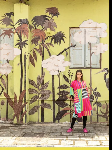 A woman photographed from a distance wearing a striped dress from Gudrun Sjödén.