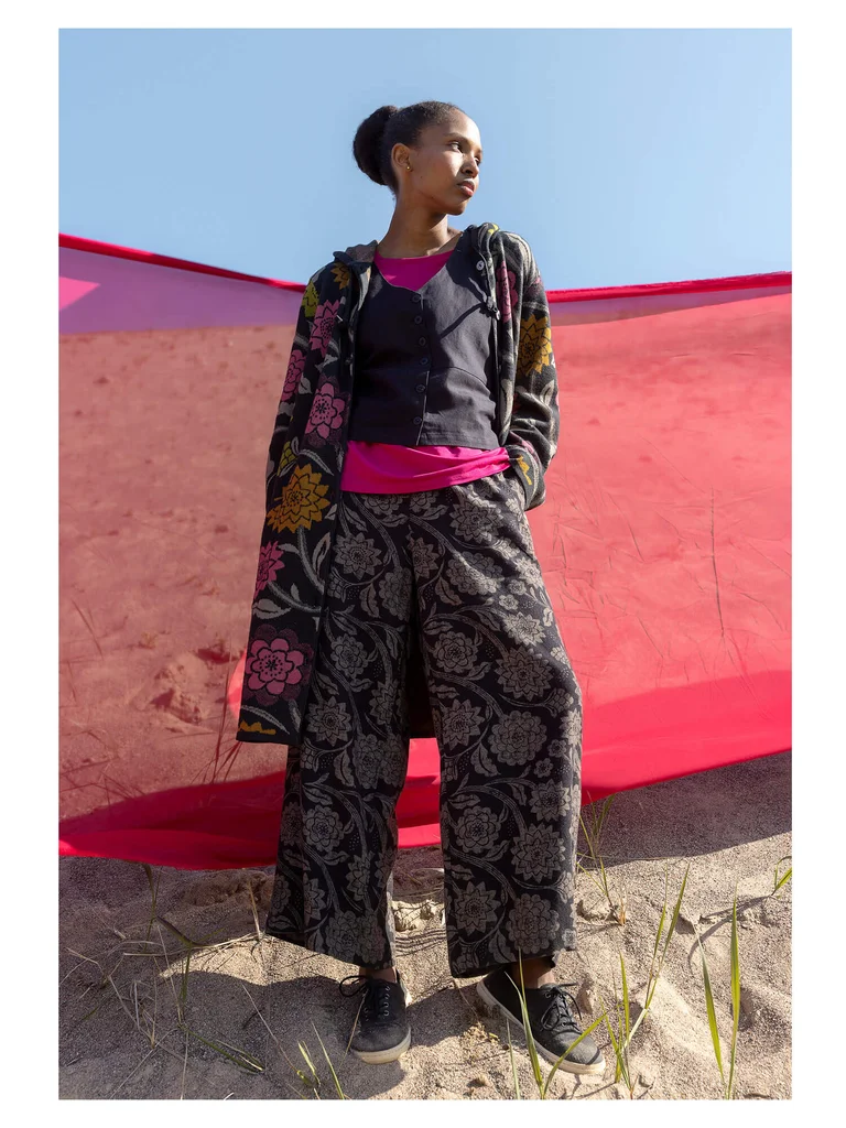 A woman wearing layers of clothing from Gudrun Sjödén.