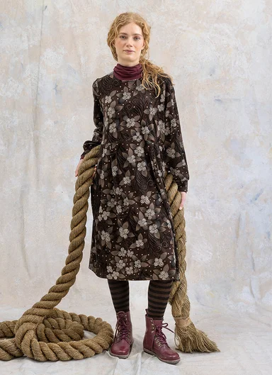 A woman wearing a patterned dress from Gudrun Sjödén.