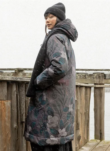 A woman wearing a floral winter jacket from Gudrun Sjödén.