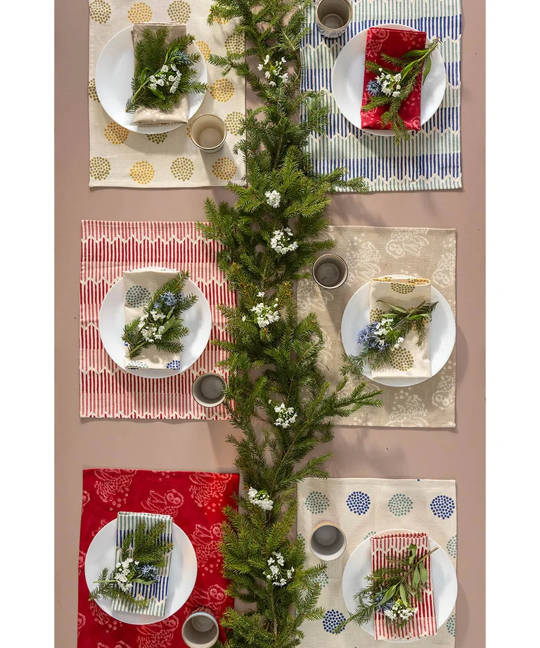 A table laid with home textiles from Gudrun Sjödén’s 2025 Christmas Home collection.