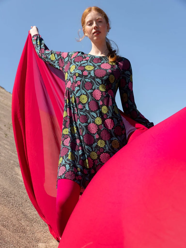 A woman wearing a floral dress from Gudrun Sjödén.