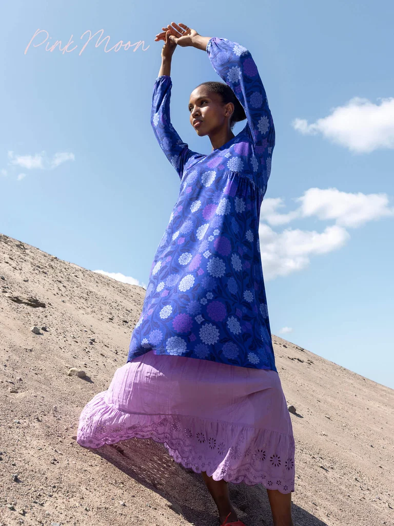A woman wearing a floral dress from Gudrun Sjödén.
