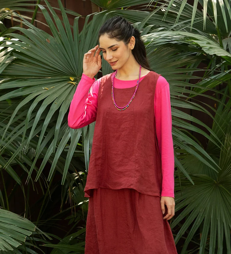 A woman wearing a red tank top and skirt from Gudrun Sjödén.
