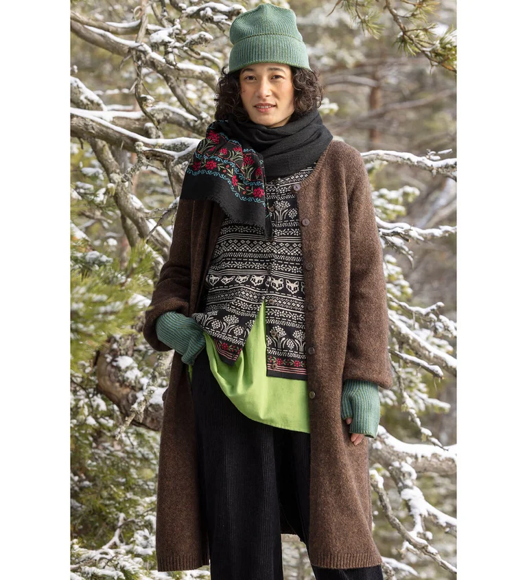 A woman wearing layers of knit clothing from Gudrun Sjödén.