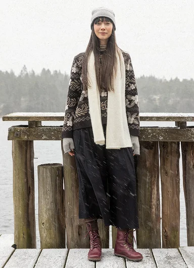 A woman wearing a floral knit sweater from Gudrun Sjödén.