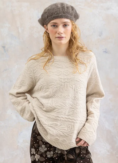 A woman wearing a knit sweater from Gudrun Sjödén.