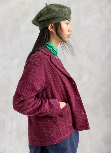 A woman wearing a corduroy jacket from Gudrun Sjödén.