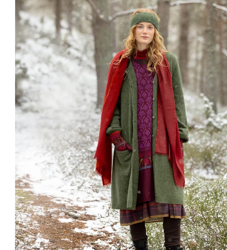 A woman wearing layers of knit clothing from Gudrun Sjödén.