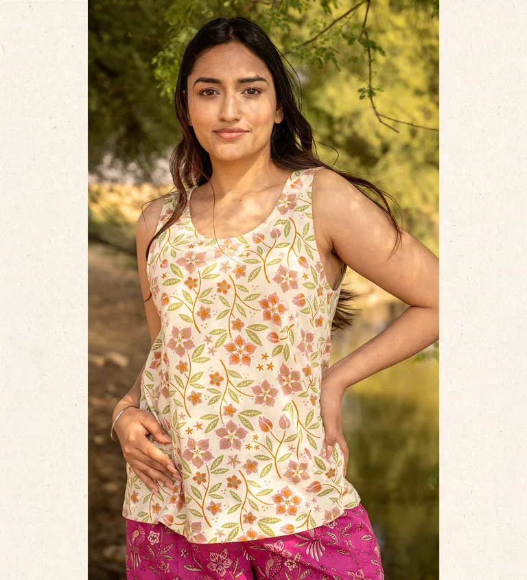 A woman wearing a floral tank top from Gudrun Sjödén.