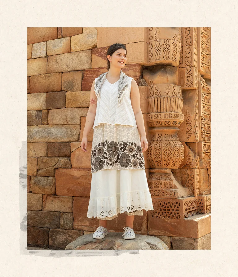 A woman wearing clothing in earth tones from Gudrun Sjödén.