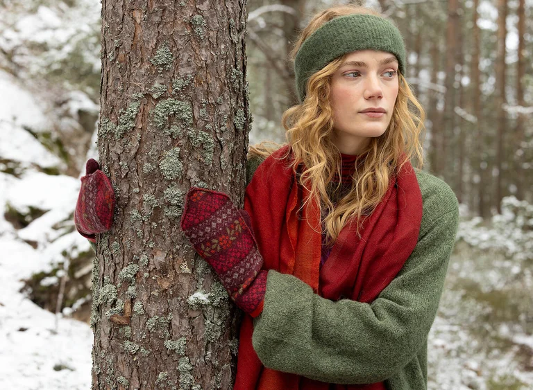 A woman wearing knit products from Gudrun Sjödén.