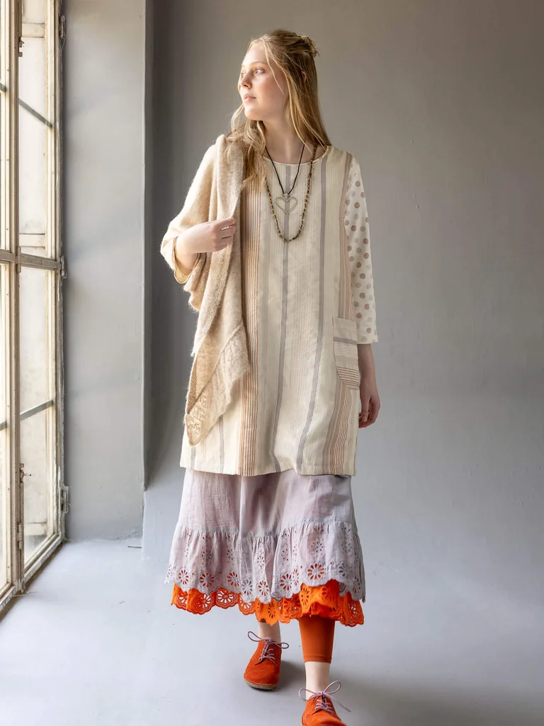 A woman wearing layers of clothes from Gudrun Sjödén’s 2025 Christmas collection.