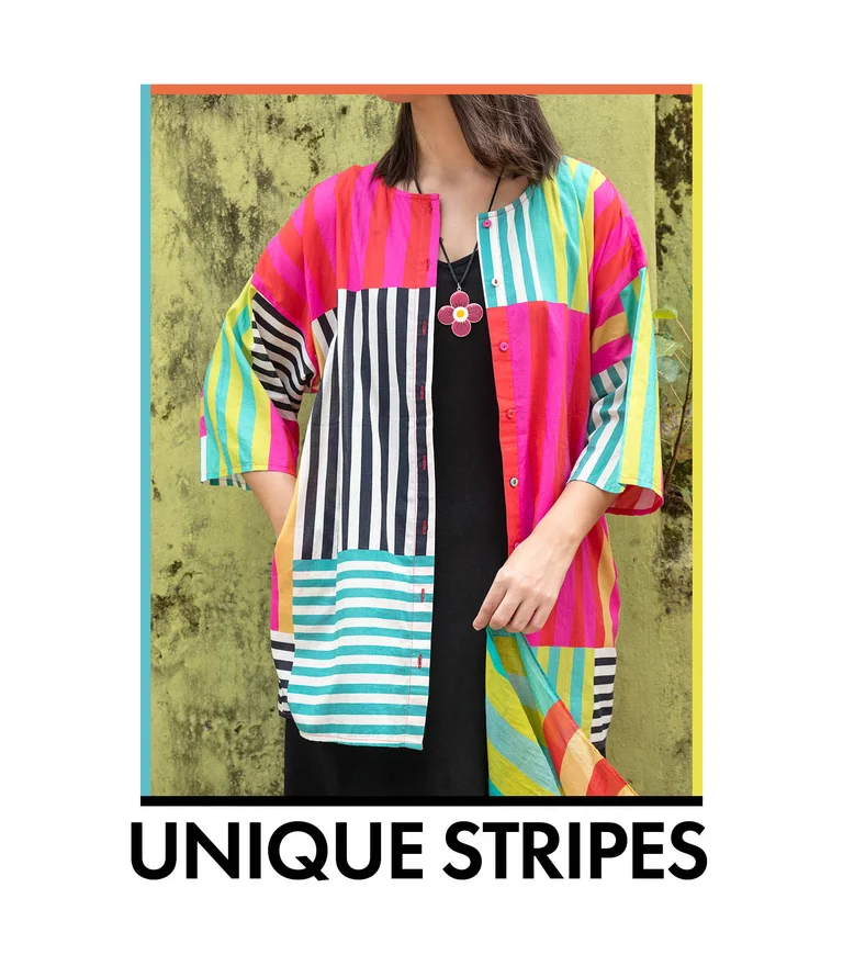 A woman wearing a colorful striped blouse from Gudrun Sjödén.