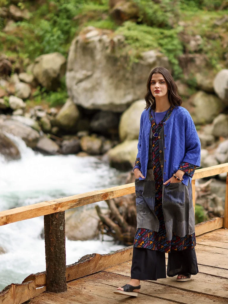 A woman wearing layers of clothing from Gudrun Sjödén.