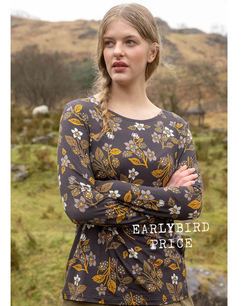 A woman wearing a patterned top from Gudrun Sjödén.