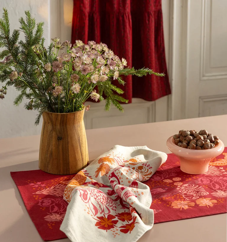 A table laid with home textiles from Gudrun Sjödén’s 2025 Christmas collection.