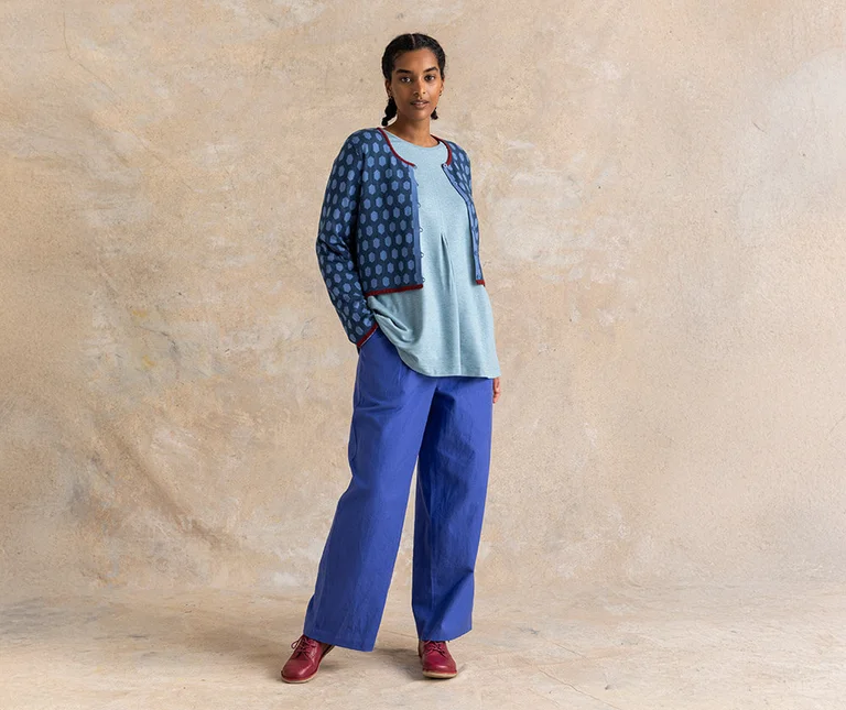 A woman wearing layers of essential clothes in shades of blue from Gudrun Sjödén.