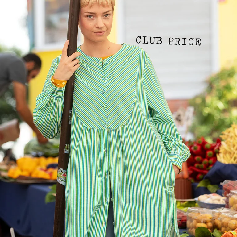 A woman wearing a striped shirt dress from Gudrun Sjödén. 