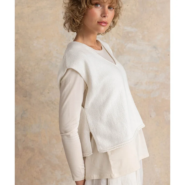 A woman wearing layers of white essentials from Gudrun Sjödén.