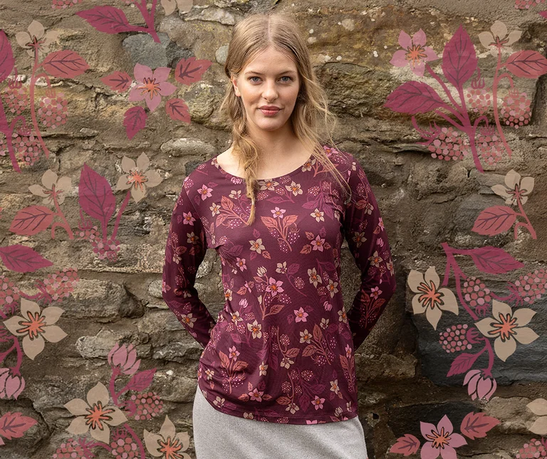 A woman wearing a patterned top from Gudrun Sjödén.