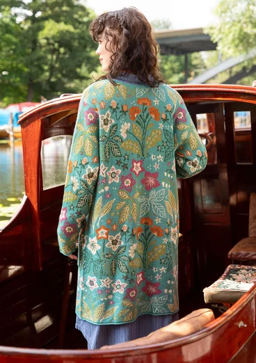 Vue arrière d'un cardigan à manches longues avec un motif floral et des boutons en bleu-vert. 
