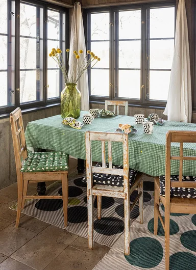 A table laid with home textiles from Gudrun Sjödén.