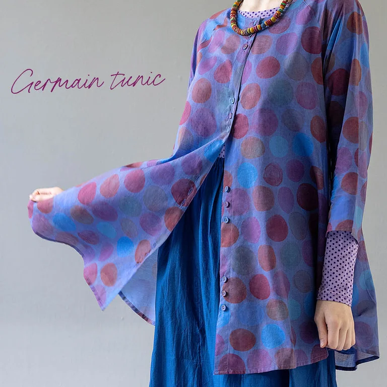 A woman wearing layers of fine blue and purple clothes from Gudrun Sjödén’s Paris collection.