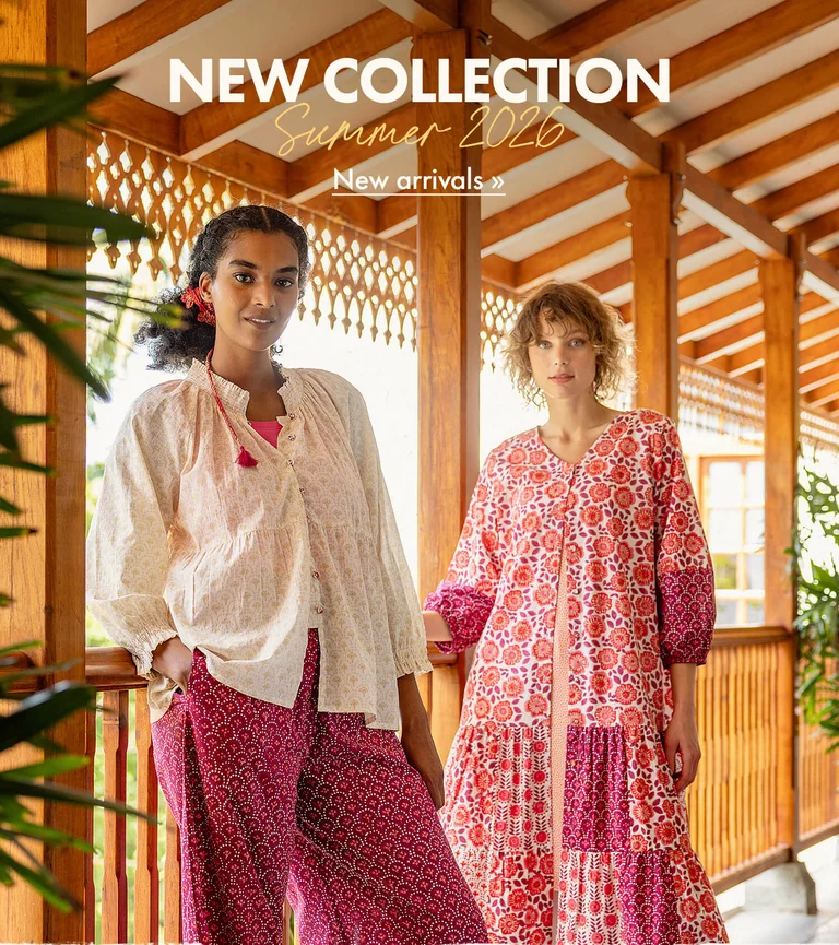 Two women wearing white and rosy-red block-print clothes from Gudrun Sjödén.