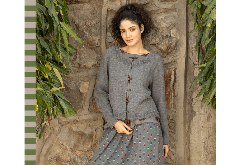 A woman wearing layers of grey clothes from Gudrun Sjödén.