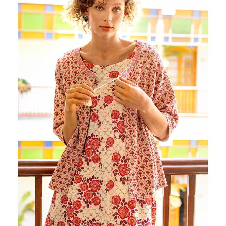 A woman wearing layers of floral clothes from Gudrun Sjödén.