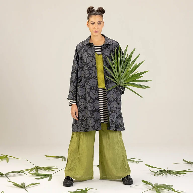 A woman wearing a grey-black, patterned coat from Gudrun Sjödén.