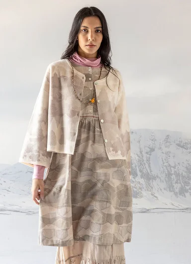 A woman wearing bright pink and red clothes from Gudrun Sjödén’s Alaska Colourful by the Sea collection, posing against a light background.