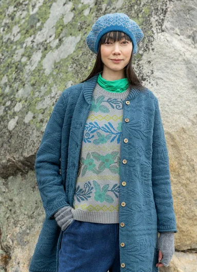 Two women standing leaning against a rock wearing clothes from Gudrun Sjödén.