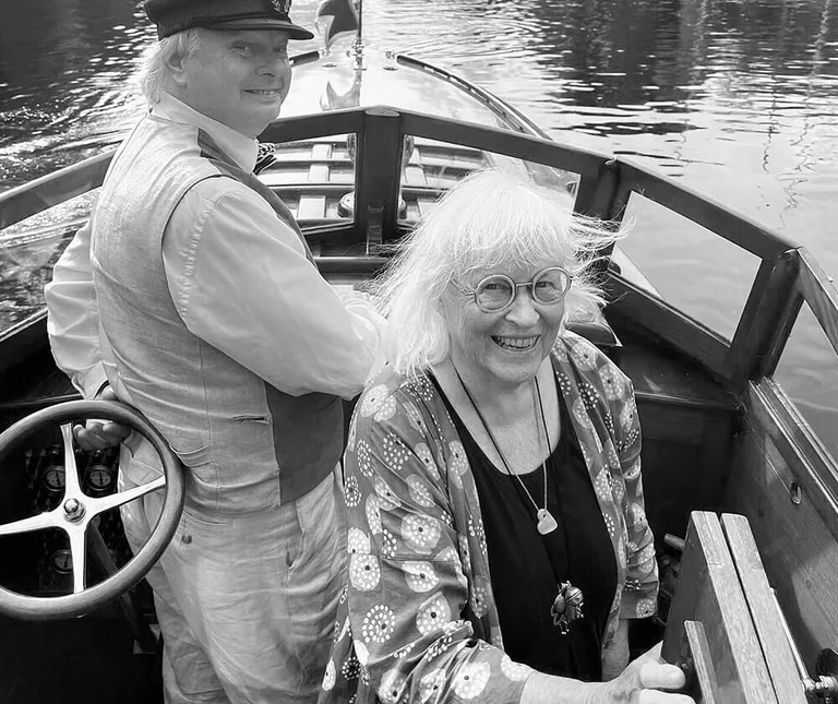 Gudrun Sjödén and a helmsman in a boat.  